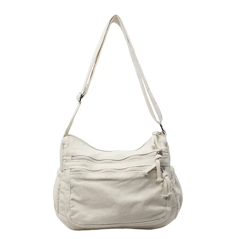 👜✨Prostorná crossbody kabelka z plátna s patinou: vyznačuje se uspořádáním s více přihrádkami na zip a širokým nastavitelným ramenním popruhem.